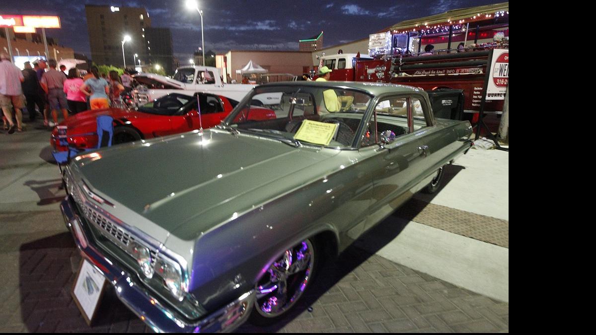 
Spectators check out a 1963 Chevy Bel Aire at the Automobilia Car Show in 2013.
