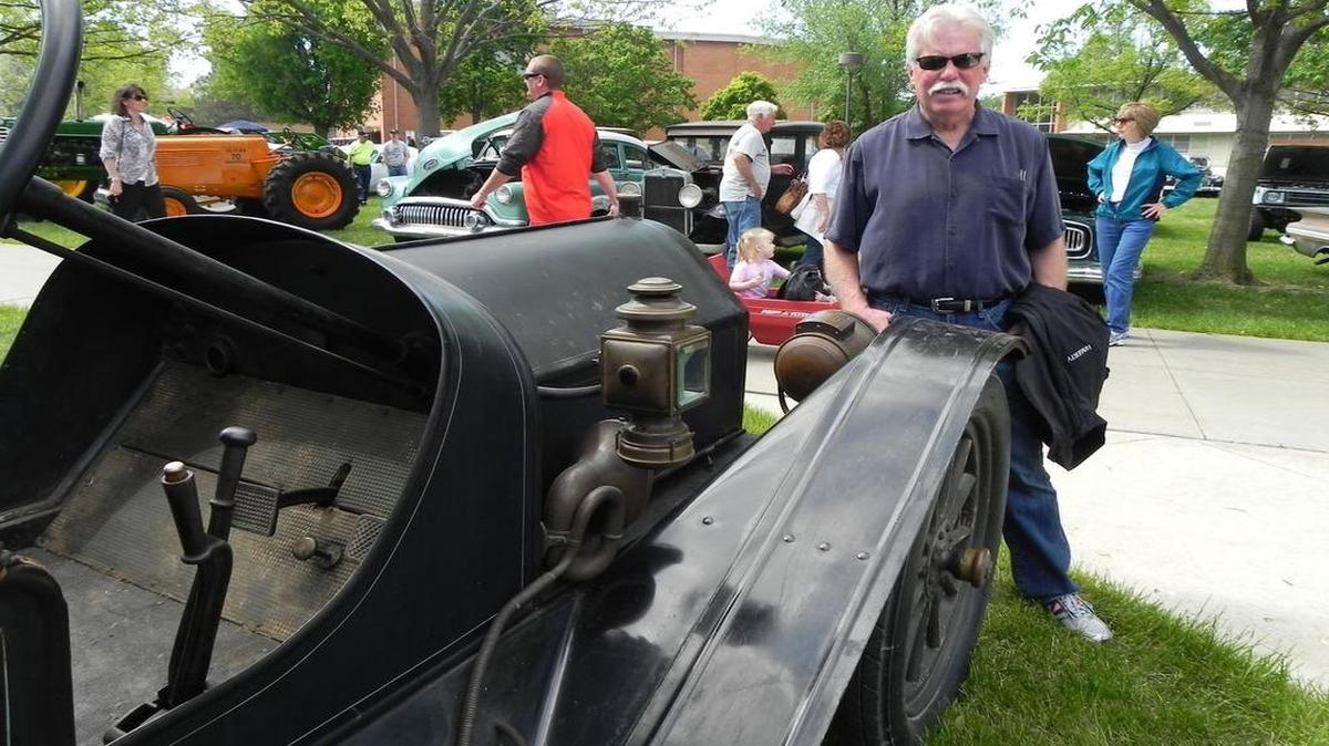 
Wayne Carini, host of the popular TV program “Chasing Classic Cars,” checks out one of the antique cars featured at the McPherson College CARS car show last weekend. 

