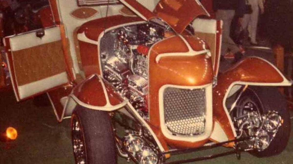 And unidentified mid-’60s full custom hot rod, with radical grille shell, pearl orange paint and canted quad headlights.