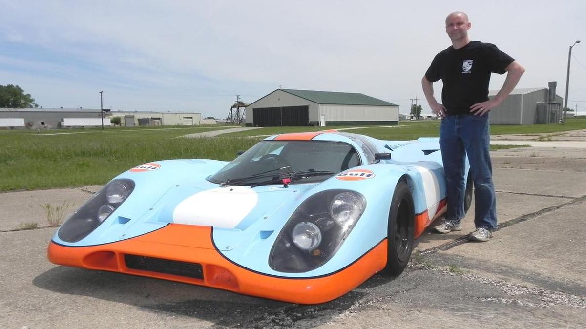 
Brian Pettey towers over his Porsche 917 replica race car. The low-slung machine clad in classic Gulf livery is a recreation of the cars that dominated LeMans in the early 1970s, but this one is street-legal. 
