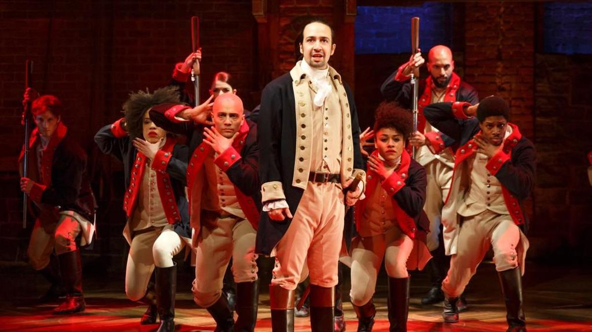This image released by The Public Theater shows Lin-Manuel Miranda, foreground, with the cast during a performance of "Hamilton," in New York. A PBS special this fall on the Tony Award-winning musical will feature at least 15 minutes of performance footage with creator Lin-Manuel Miranda and his team.