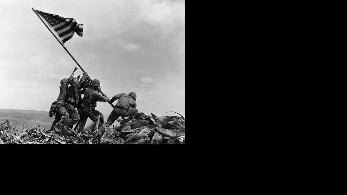
U.S. Marines of the 28th Regiment of the Fifth Division raise the American flag atop Mount Suribachi, Iwo Jima, on Feb. 23, 1945. Strategically located only 660 miles from Tokyo, the Pacific island became the site of one of the bloodiest, most famous battles of World War II against Japan.

