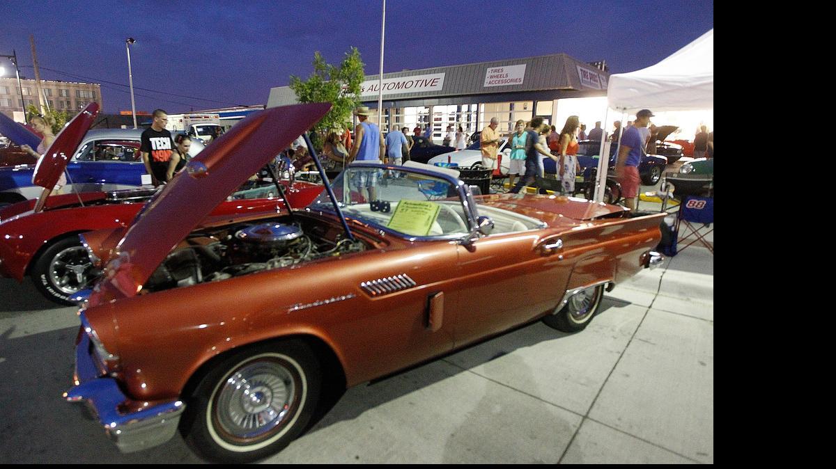 
Spectators check out a 1957 Ford Thunderbird at the 2013 Automobilia show.
