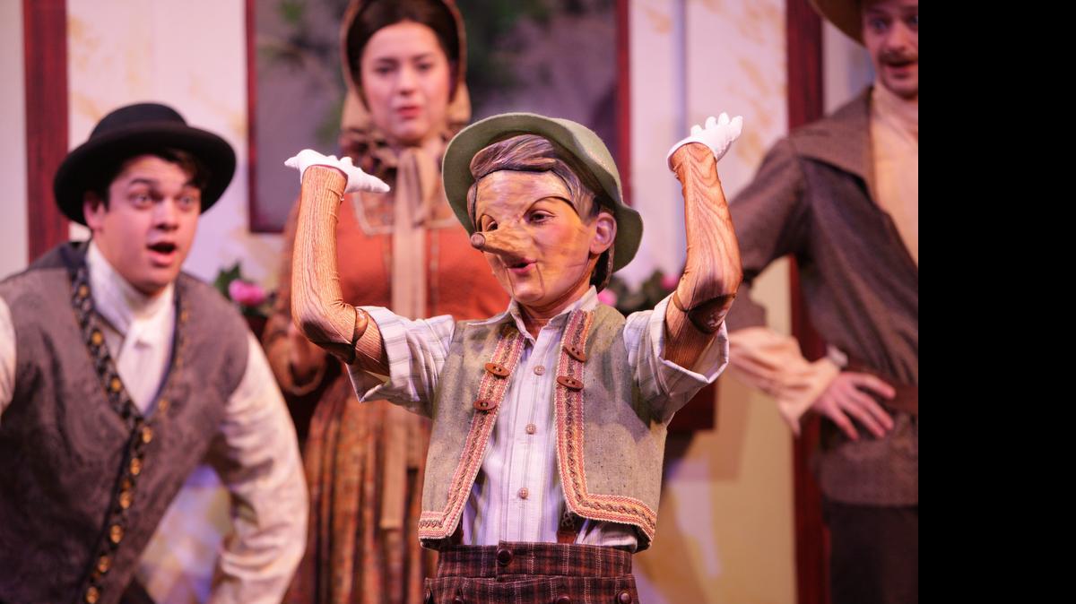 
Pinocchio (Topher Cundith) sings “I’ve Got No Strings” as Geppetto (Nicholas F. Saverine) and villagers watch him in “My Son Pinocchio.”
