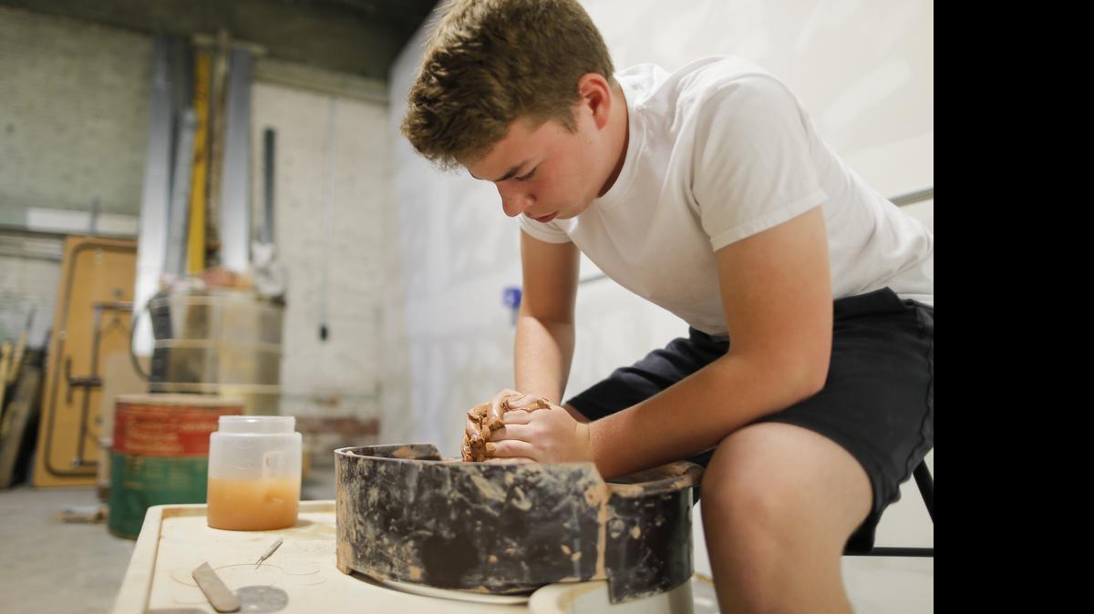Sean Whalen works on a pottery wheel at the MakeICT office on east Douglas on Saturday. MakeICT, a nonprofit group of engineering-artist-musician innovators, is hosting the Makers Faire on Saturday at Exploration Place.