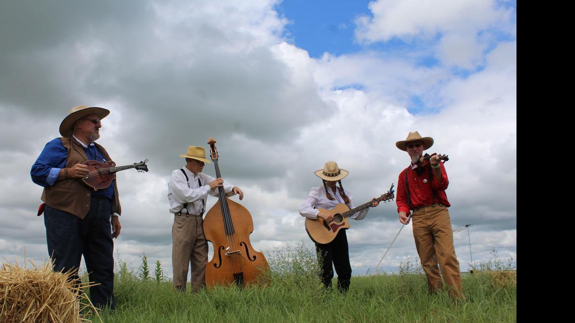 
Tallgrass Express String Band musicians, from left, Jim Versch, Carl Reed, Anne Wilson and Kim Schmidt provide the welcome music for guests of the Symphony in the Flint Hills. Despite weather concerns, the event, held at the Tallgrass Prairie National Preserve, was expected to draw more than 7,000 concertgoers from all over the world. 
