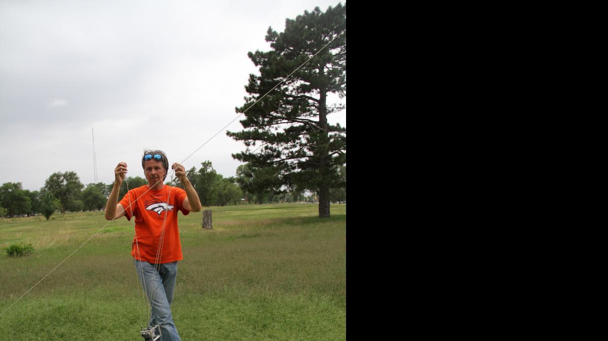
Gerco de Ruijter attaches a camera to the line of a kite. The photographer’s works will be on display at the Ulrich Museum of Art through Sept. 13.
