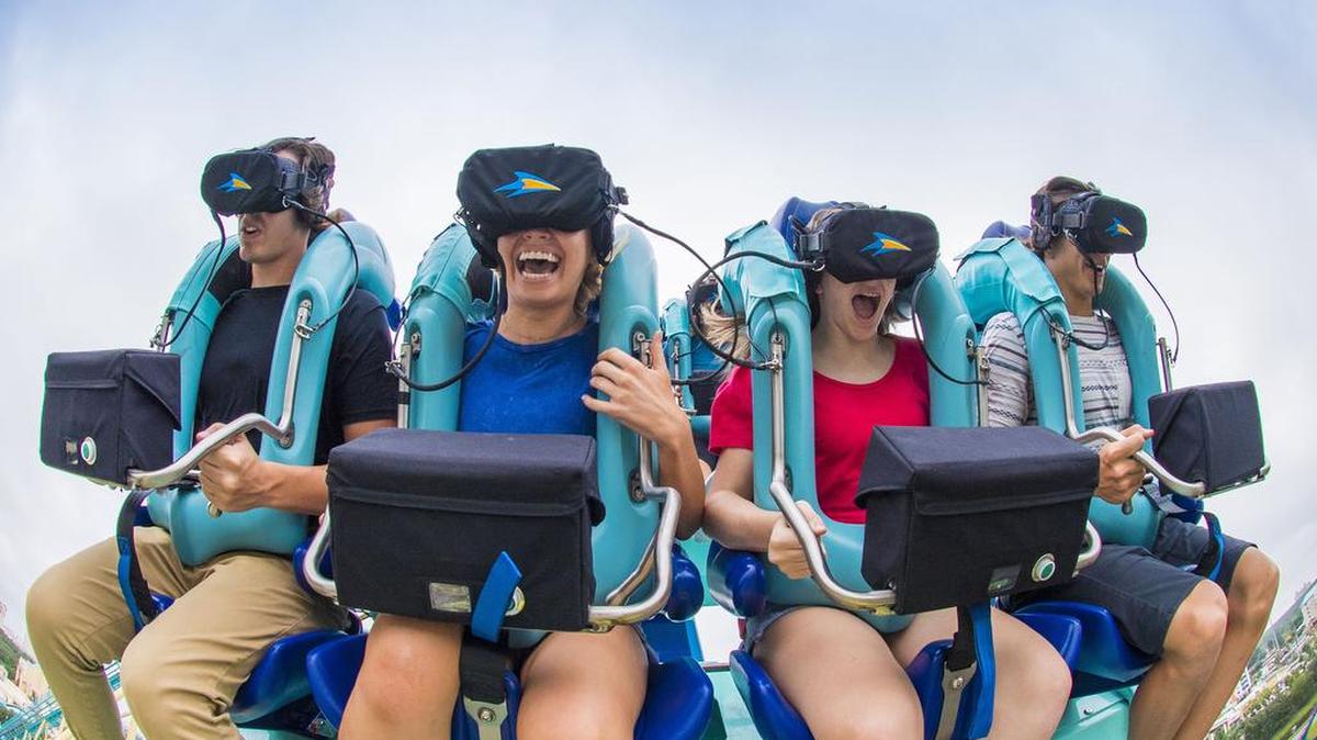 As Kraken speeds through a loop and turns upside down, riders wearing virtual reality headsets are experiencing an undersea adventure.