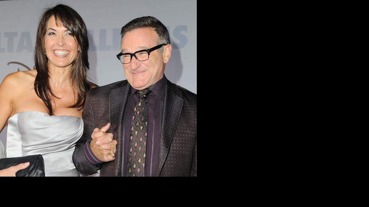 
FILE - This Nov. 9, 2009 file photo shows actor Robin Williams, right, and his wife Susan Schneider at the premiere of "Old Dogs" in Los Angeles. Williams, whose free-form comedy and adept impressions dazzled audiences for decades, died Monday, Aug. 11, 2014, of suicide. Williams was 63. 
