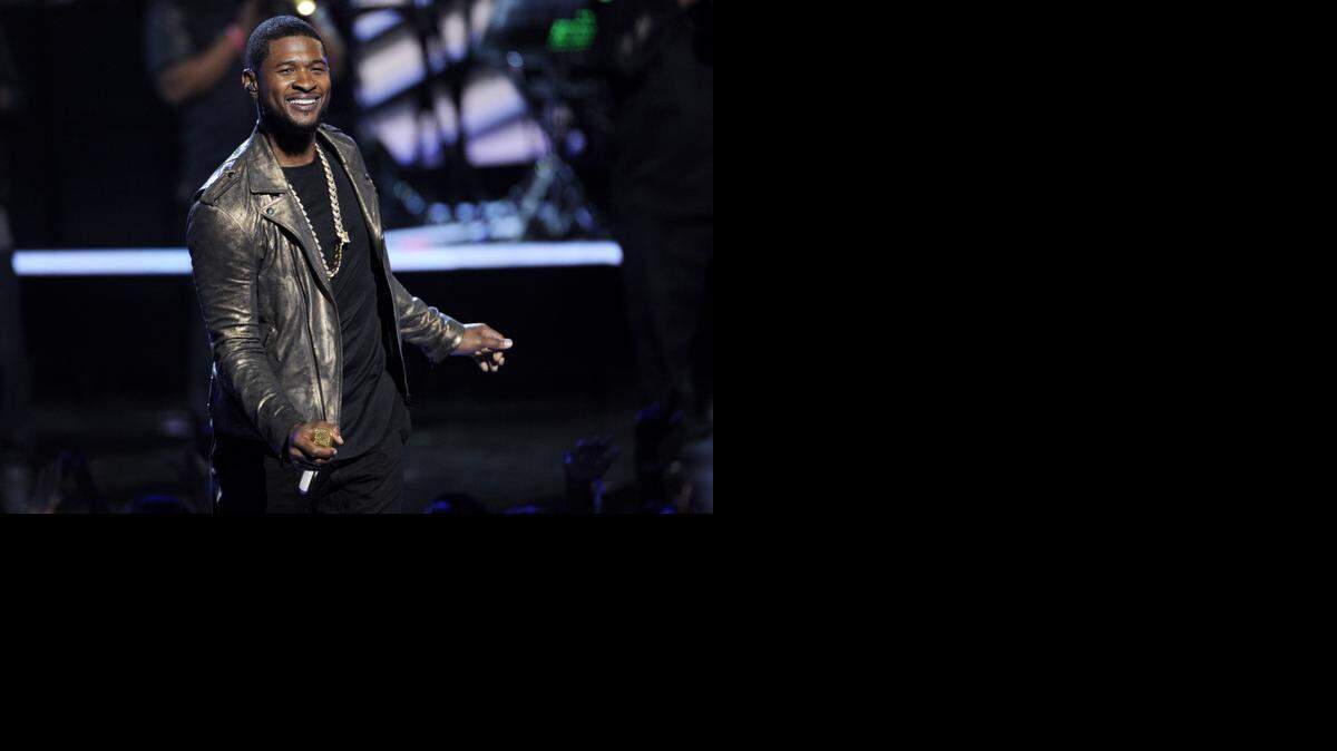 
FILE - In this June 29, 2014 file photo, Usher performs at the BET Awards at the Nokia Theatre in Los Angeles. Usher launches his UR Experience World Tour in Montreal on Saturday, Nov. 1.
