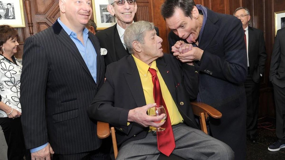 Jeff Ross, left, Richard Belzer, and Jim Carrey, right, joke with entertainer Jerry Lewis at the Friars Club before his 90th birthday celebration on Friday, April 8, 2016, in New York.