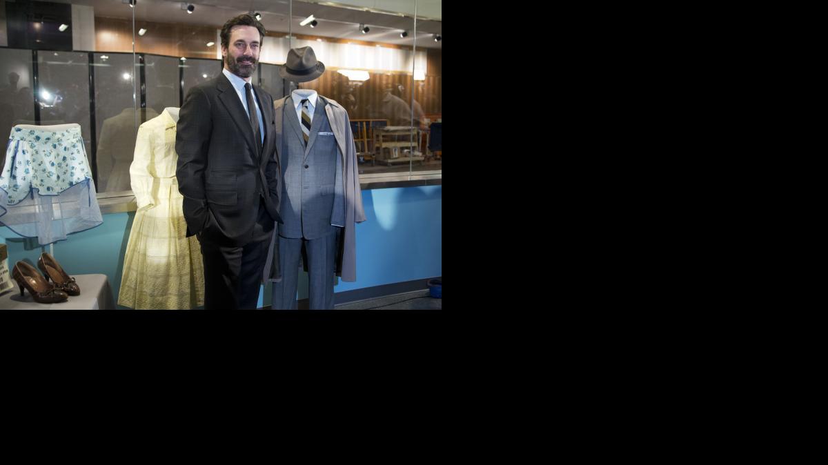 
“Mad Men” star Jon Hamm, who played Donald Draper, poses beside Don’s charcoal gray suit and other objects from the AMC and Lionsgate TV series that were donated to the National Museum of American History.
