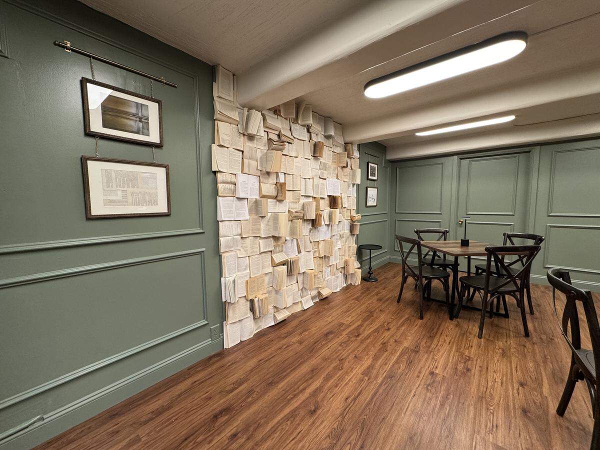 The Authors’ Gallery in the basement of Watermark Books & Cafe has been remodeled and will be used for overflow seating and private events. The owners installed a unique art piece made using actual books.