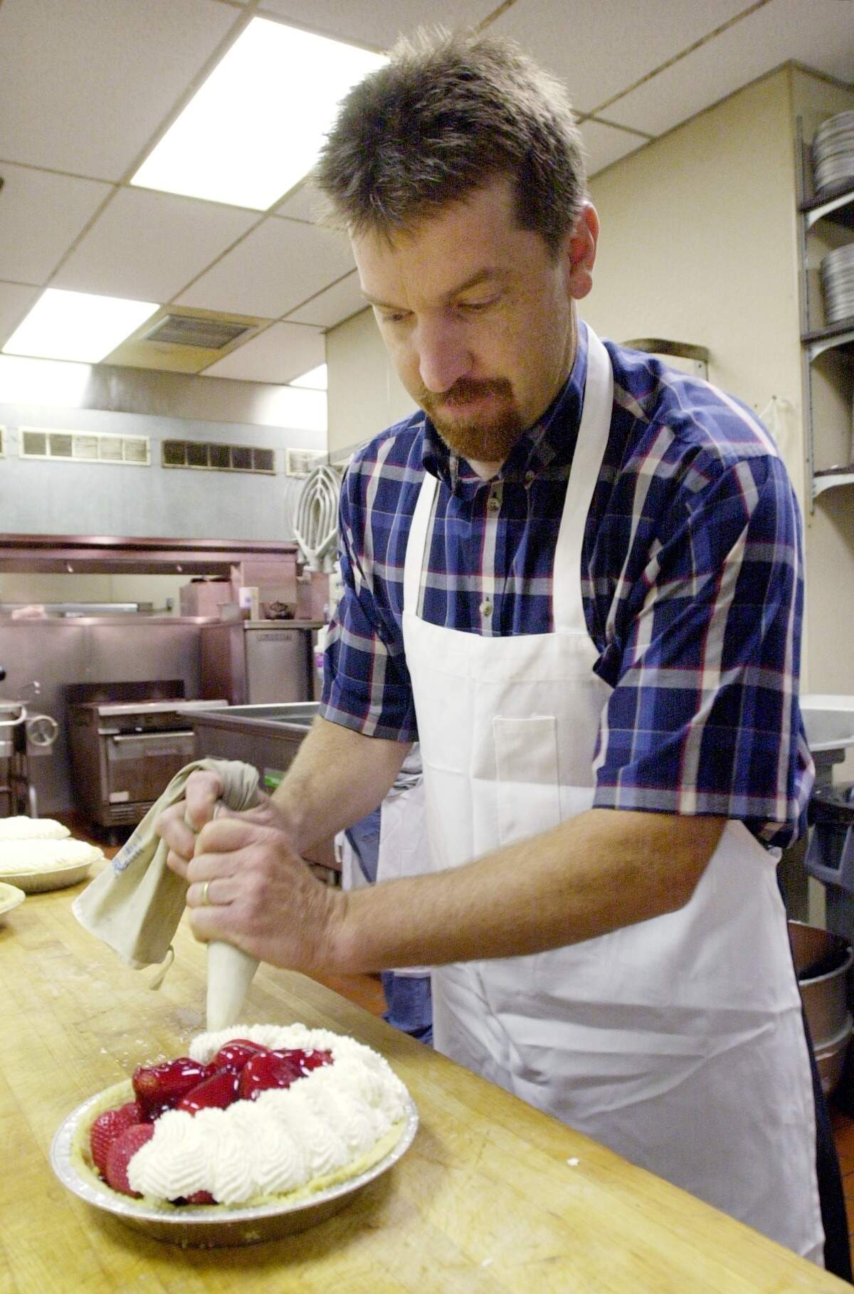 Dan Crandall is pictured preparing a strawberry glaze pie in 2005. Crandall, who now owns the restaurant, started there as a manager in 1988
