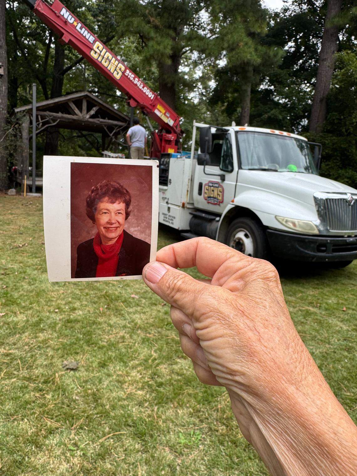 Robin Macy’s mother, Frances, left her some money when she died in November 2024, and Macy used it to buy the old Victory Theater sign for the Bartlett Arboretum. Macy kept a picture of her mother with her as the sign was recently installed.