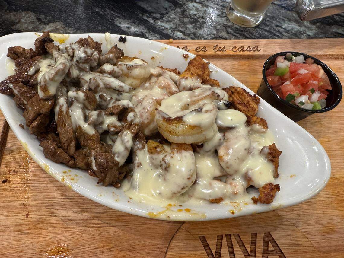 Texas Dip C features tender steak, chicken and shrimp drenched in melty queso.