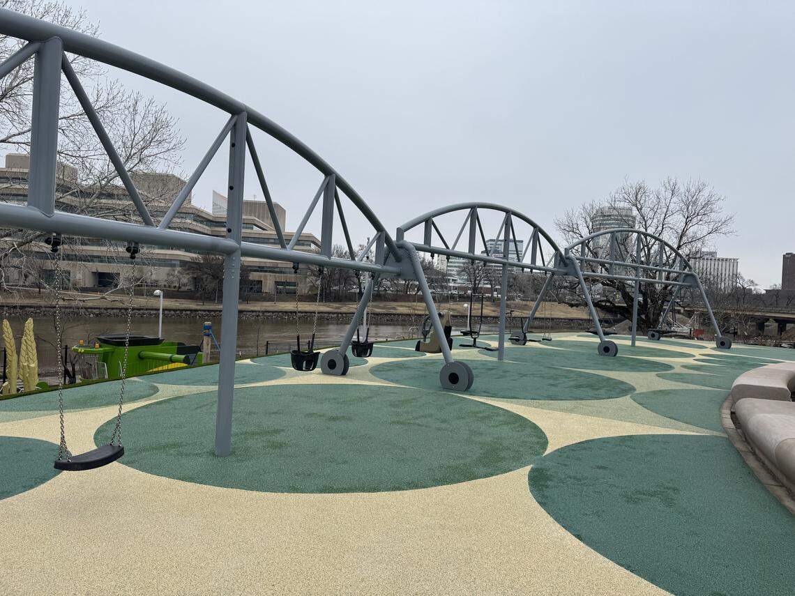 The frame of a swing set at Exploration Place’s new Adventure Playscape is designed to look like a center pivot irrigation system.