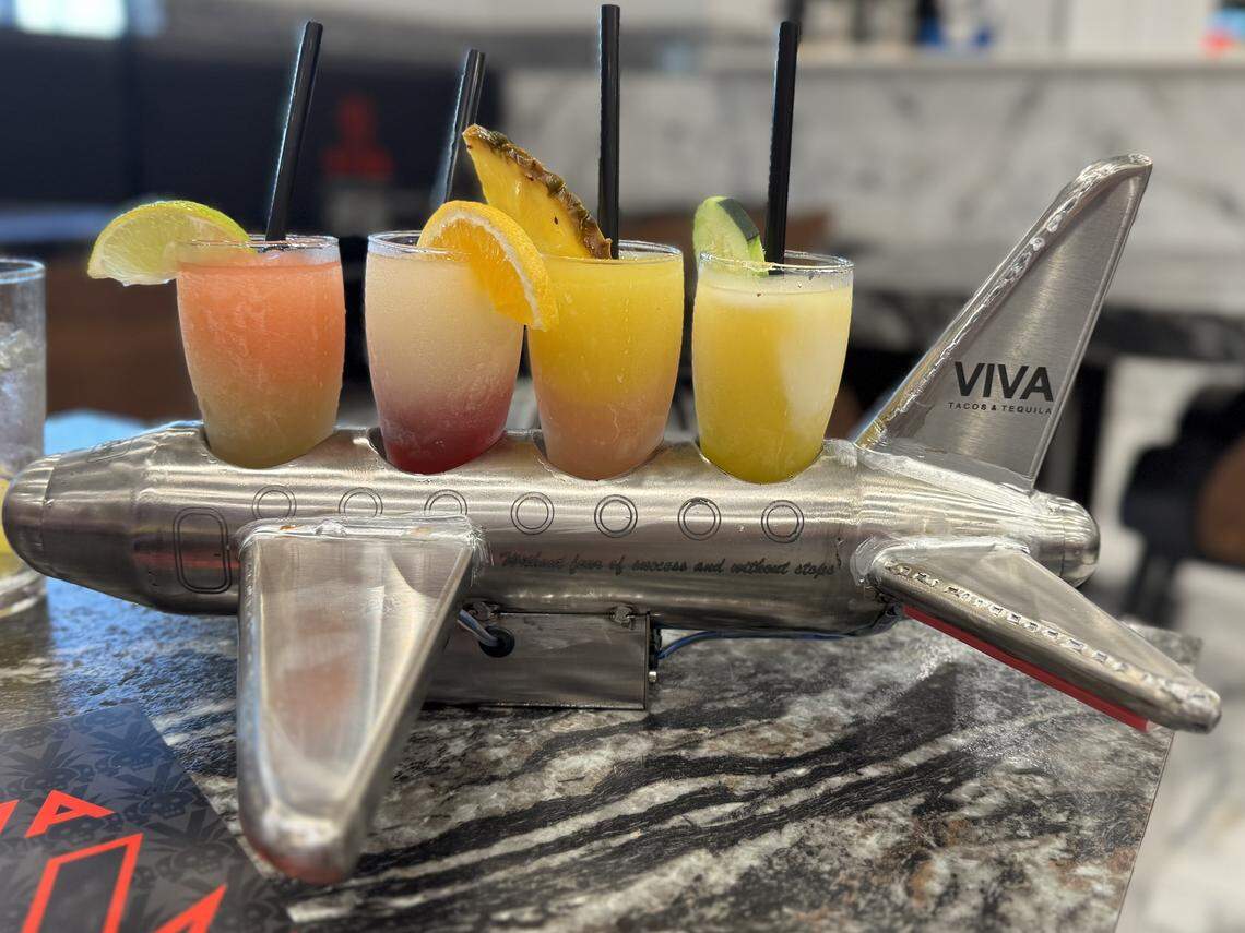 The bar at Wichita’s new Viva Tacos & Tequila offers many different flavors of margaritas. Some are served in a tiny tabletop airplane.