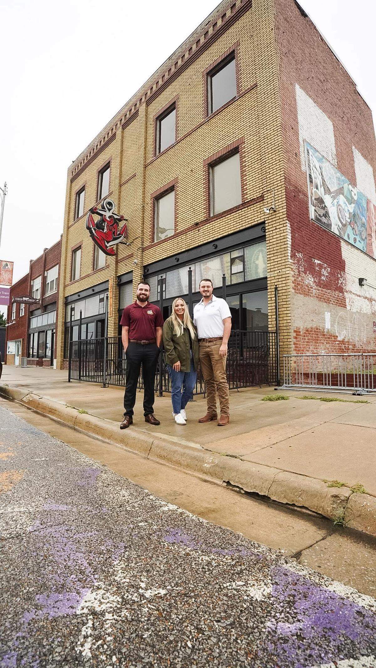 Adam Church, left, Bobbie Lane, center and her husband Jonathan Lane, right, purchased The Anchor building when it was auctioned in July.