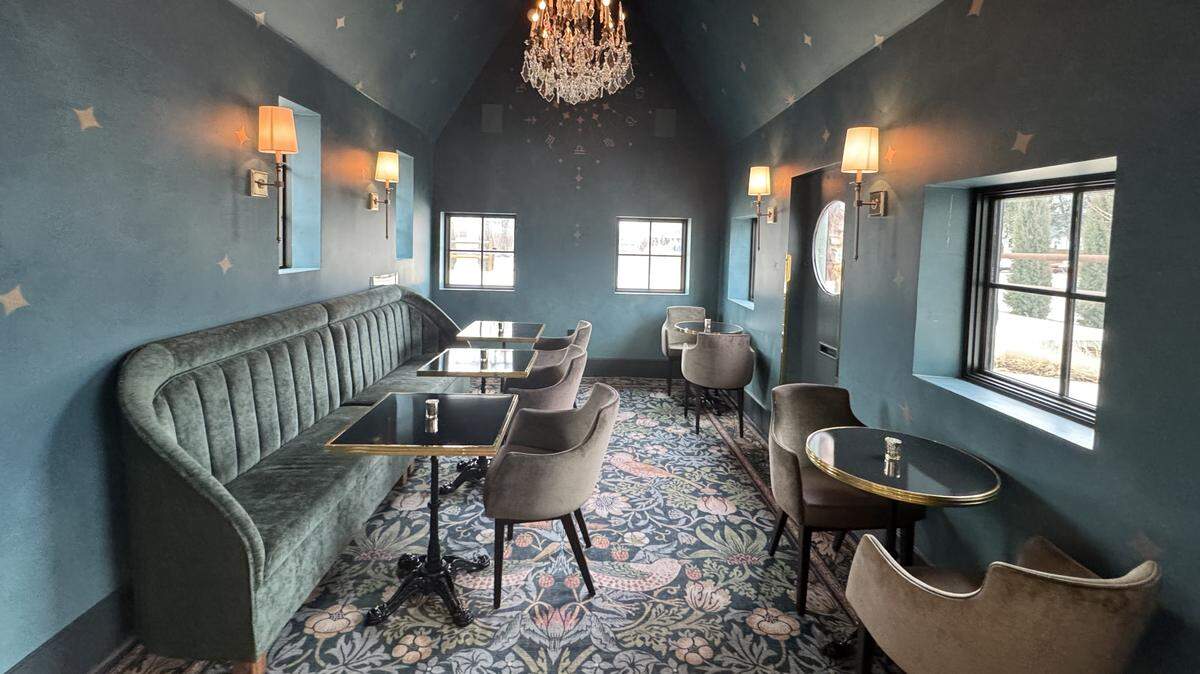 Goldfinch Coffee and Cocktails includes several rooms decorated with plush furnishings and salvaged chandeliers.