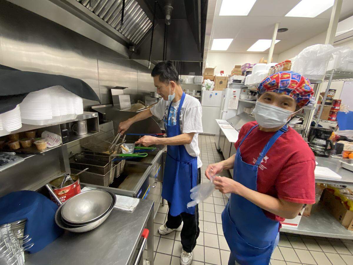 Mike and Yook Gan are pictured in the kitchen of their restaurant Asian Wok shortly after it opened at 2929 N. Rock Road in 2021.
