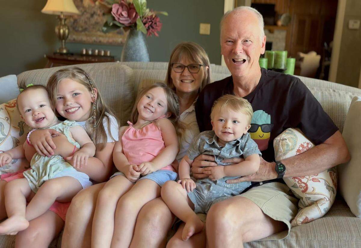 Francie Foster is pictured with her husband, Norm, and their four grandchildren.