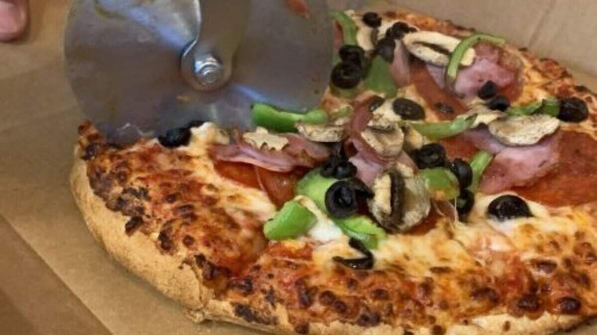 Pizza Shuttle's Express pie is topped with pepperoni, ham, mushrooms, onions and green peppers.