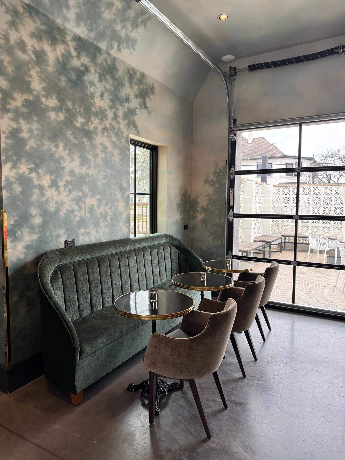 The tree mural on the walls of the new Goldfinch Coffee and Cocktails in Wichita was painted by a local artist and set designer.