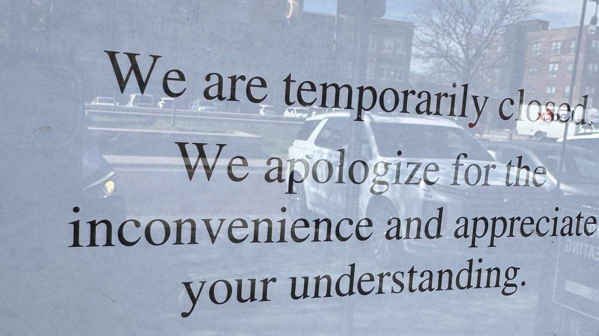 This sign has been posted on the front door of Sushiya in Old Town Square for several weeks.