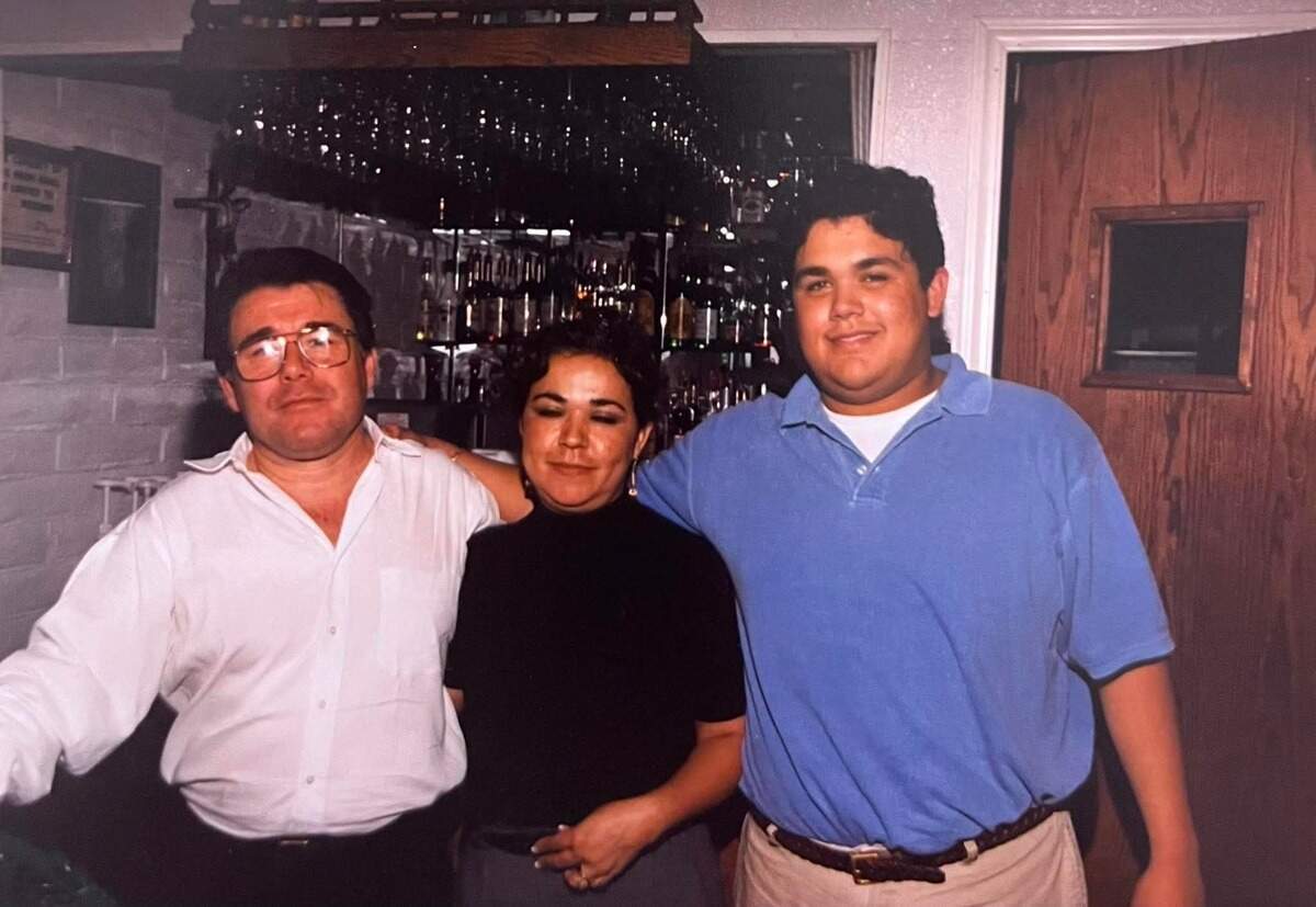 Jose Armando Martinez, right, is pictured in the late 1990s at his family’s restaurant, Felipe’s Jr., with is parents Martin and Arcelia Martinez. Courtesy