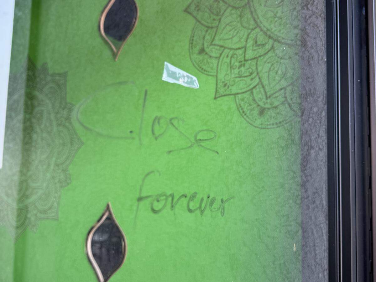 A sign scrawled on one of the doors to The Mango Tree restaurant at 47th and Broadway