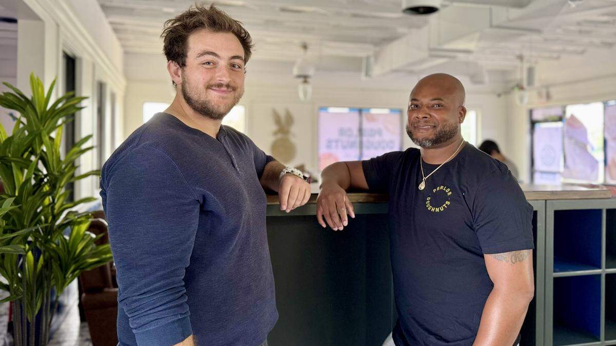 William Harrington, left, will be the general manager of Wichita’s first Parlor Doughnuts. He’s pictured in the shop at 7010 W. 21st St. with franchisee Byron Smith.