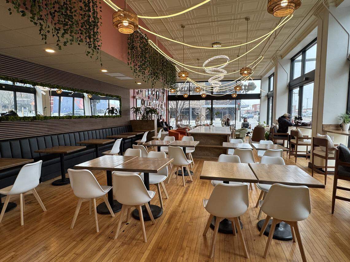 The large seating area at 11:11 Coquetry Maison features high-top and low-top tables, hanging bamboo chairs, window seating and banquette seating.