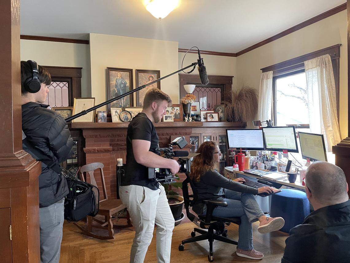 Graham High and his Wichita film crew, which included Barrett Gagne, left, and Joshua Gerber, center, are photographed while interviewing The Wichita Eagle’s Denise Neil, seated, for the documentary “Ford Comes to Wichita.”