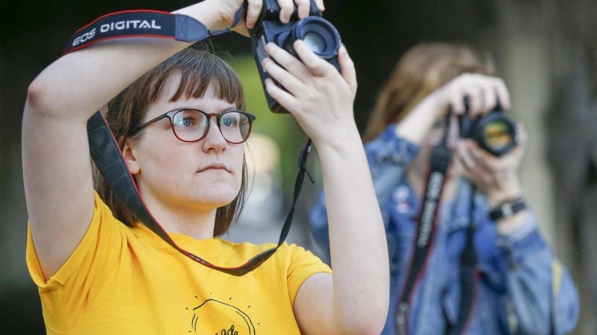 Instagram photographers Bailey Tredway, left, and Caroline Ragatz take pictures in downtown Wichita on Monday. (April 10, 2017)