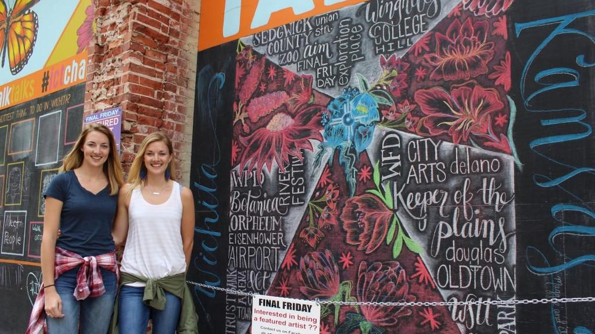 Maggie Newlin, left, and Ellie Newlin, right, created this Wichita-themed mural as part of ICT Chalk Talks.