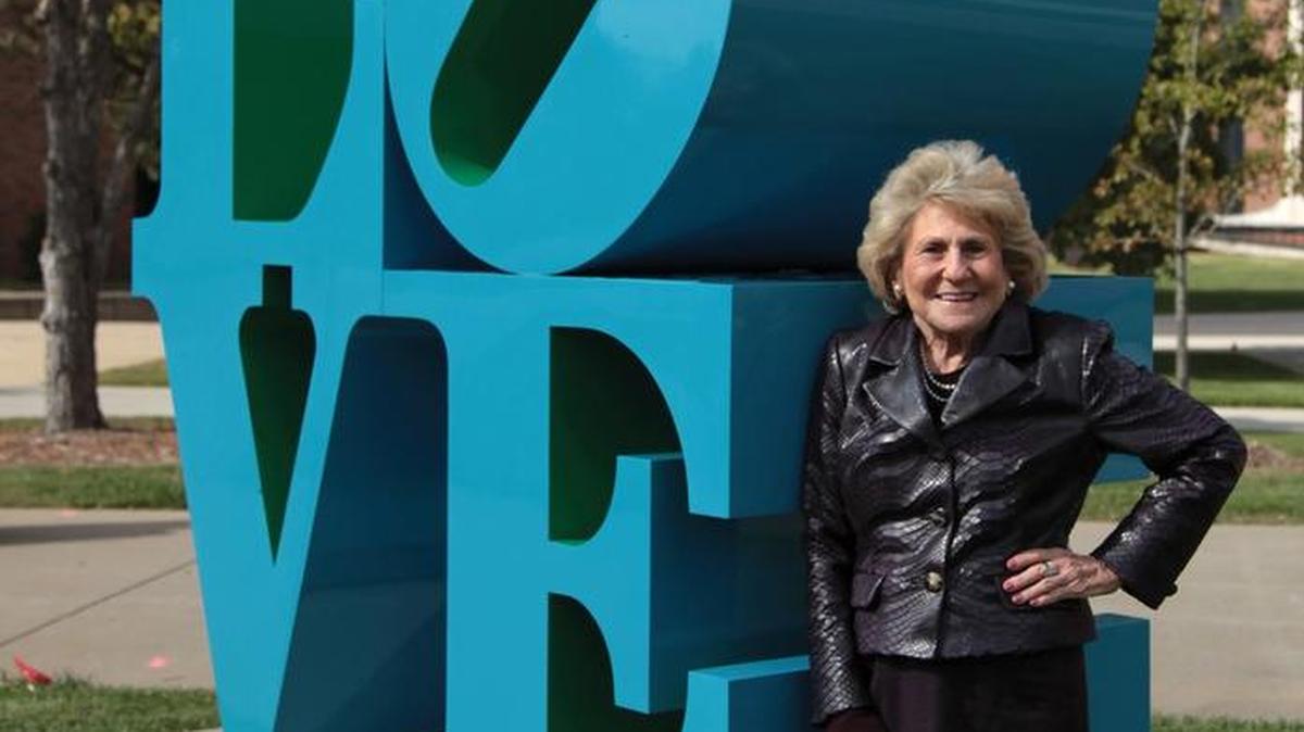 Joan Beren with Robert Indiana’s “Love” sculpture, part of Wichita State’s Martin H. Bush Outdoor Sculpture Collection.