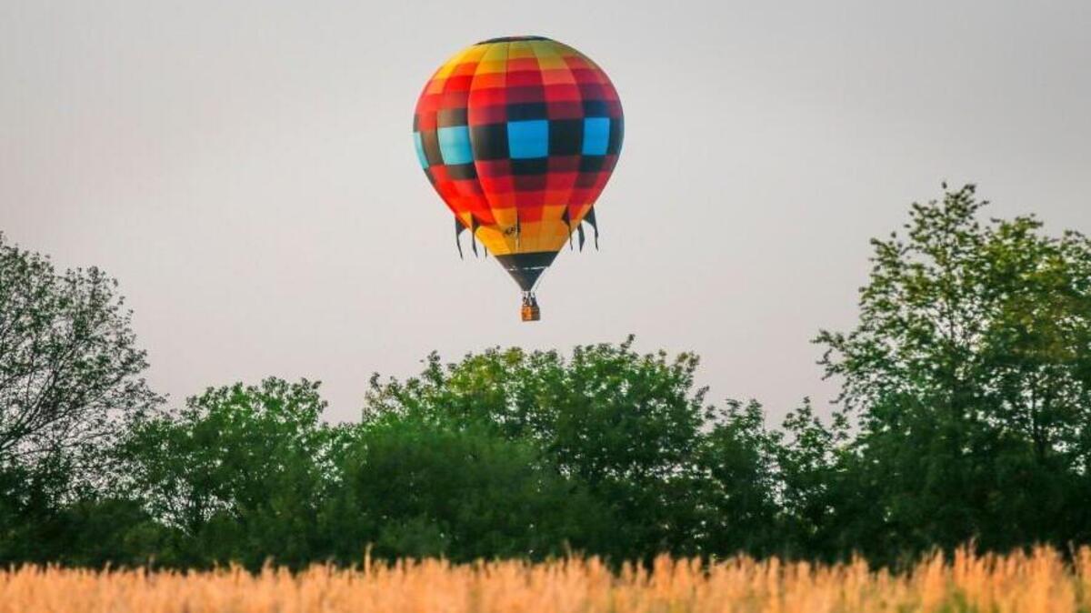 Hot air balloon enthusiasts aboard the S.S. Journey go for a ride through southwest Topeka last year. Many balloonists will be in Anthony this weekend for the Sunflower Balloon Festival.