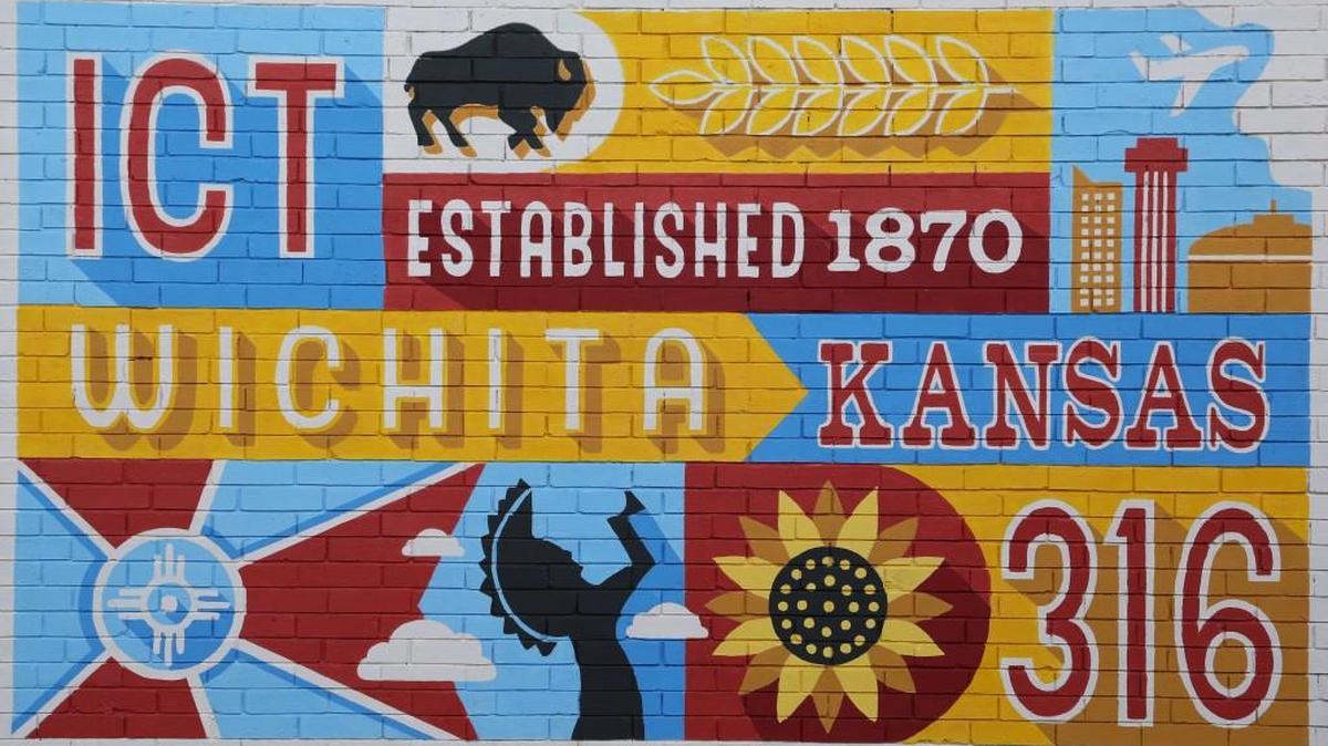 Josh Tripoli and Rebekah Lewis designed a Wichita mural that’s on the west wall of the College Hill Deli and it has become one of the most popular places to take a picture.