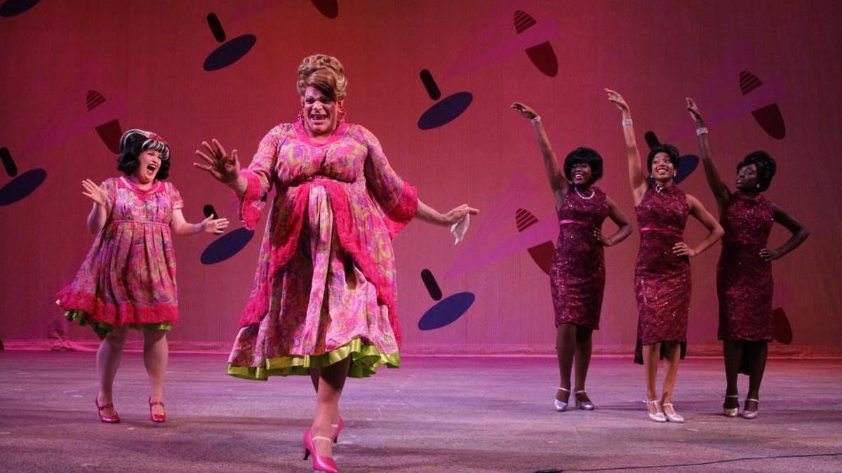 Edna Turnblad (Sam Zeller, center) is thrilled by the makeover inspired by daughter Tracy (Claire Manship) and celebrated by the Dynamites in “Hairspray.”