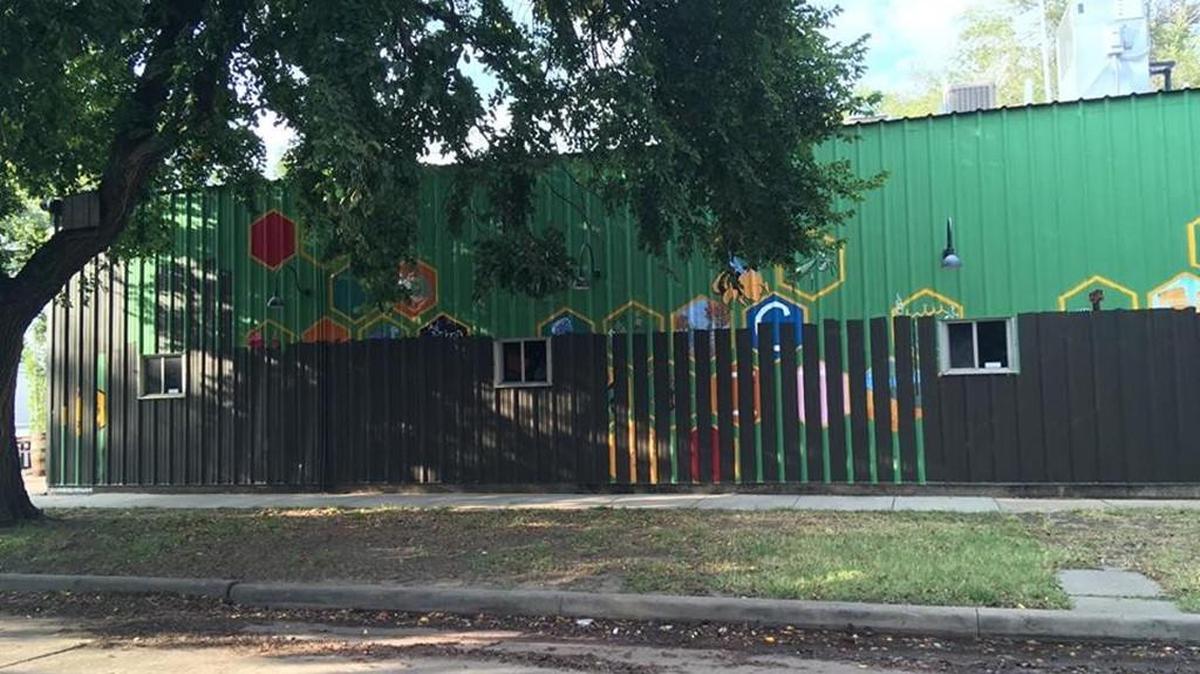 A couple of weeks after Avenue Art Days, “Cross Poli-Nation” was painted over. The wall is now solid black.