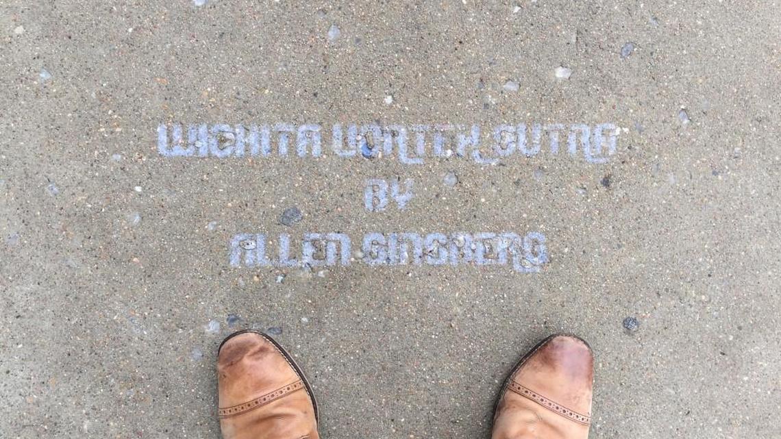 The Yellowbrick Street Team painted five separate quotes from Allen Ginsberg’s “Wichita Vortex Sutra” – including this title quote – along the south sidewalks on Douglas on Sunday.