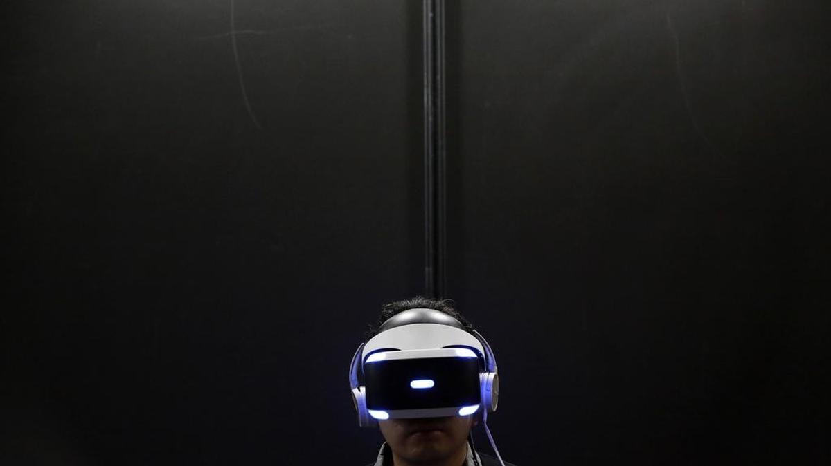 A visitor tries out a Sony PlayStation VR headgear device at the Tokyo Game Show on Sept. 15. Sony’s system, which comes out Oct. 13, delivers where it matters most to hard-core gamers.