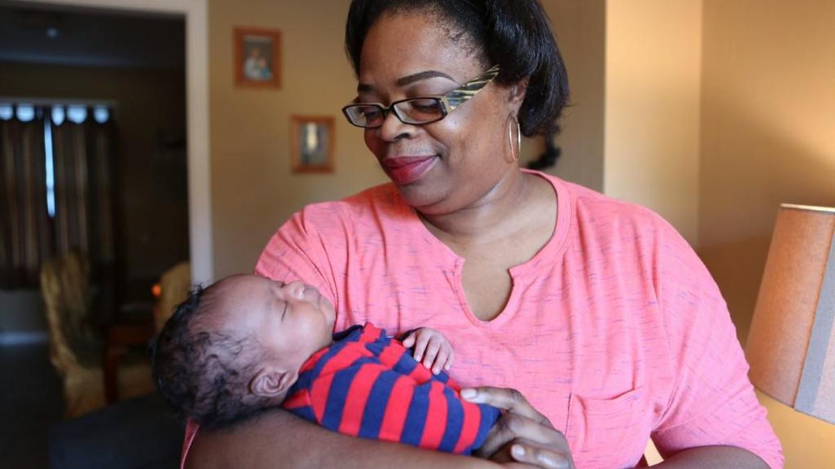 LaSherrie Herndon holds her week-old grandson Jaxson Everett. Herndon had surgery earlier this year and fell behind on her monthly bills. (Nov. 22, 2016)