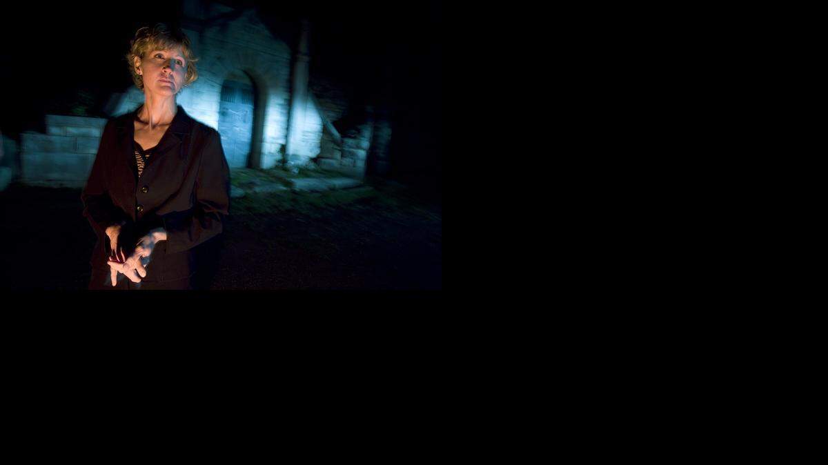 
Cathy Ramirez walks around the Topeka Cemetery. Ramirez’s company offers ghost tours of different areas of Kansas. 
