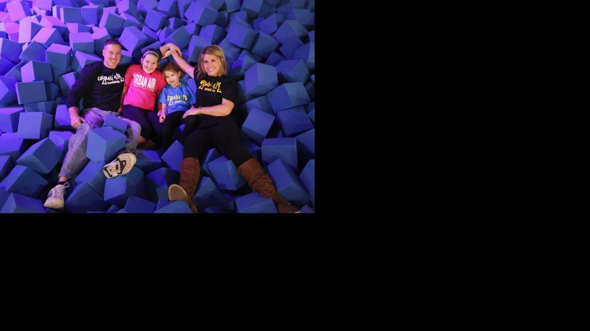 
Jon and Annie Becker recently opened up Urban Air Trampoline Park recently opened at 8545 W. Irving St. In the foam pit with them are their daughters Hailey, 9, and Allie, 7. (Dec. 29, 2014)

