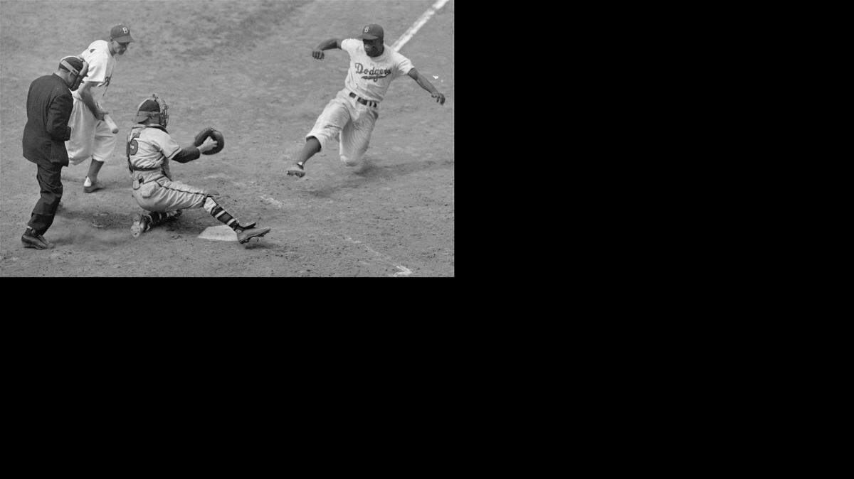 
Brooklyn Dodgers Jackie Robinson, steals home plate as Boston Braves’ catcher Bill Salkeld is thrown off-balance on pitcher Bill Voiselle’s throw to the plate during the fifth inning at Ebbets Field in New York on Aug. 22, 1948. The umpire is Jocko Conlan. On Oct. 24, 1972, Robinson, who’d broken Major League Baseball’s color barrier in 1947, died in Stamford, Connecticut, at age 53.

