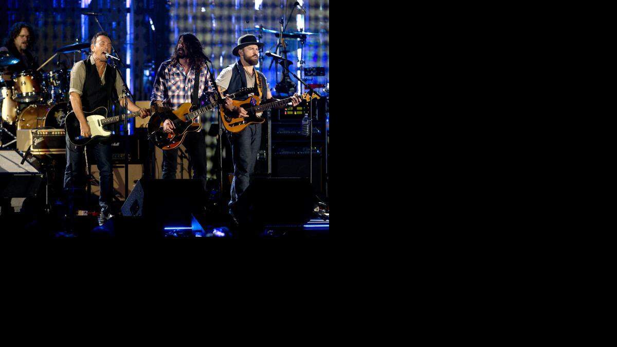 
From left, Bruce Springsteen, Dave Grohl, and Zac Brown, sing on the National Mall in Washington, Tuesday, Nov. 11, 2014, during the Concert for Valor. The Veterans Day event was hosted by HBO, Starbucks and Chase and was free to the public.
