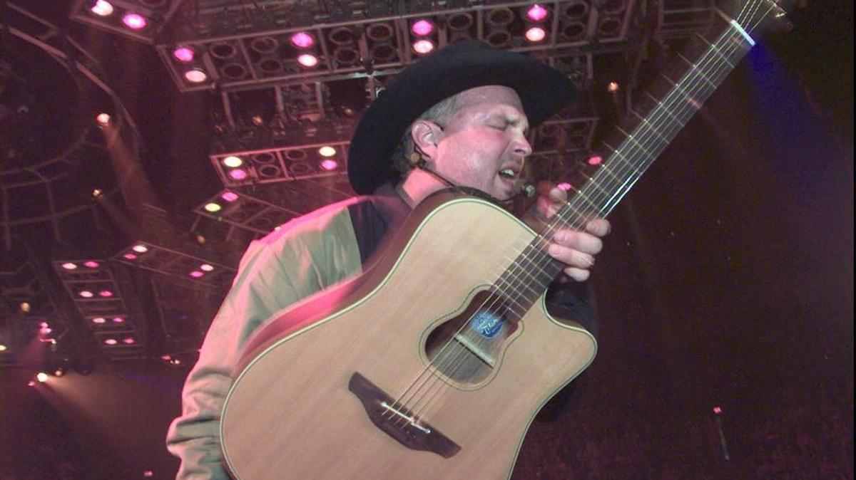 
Garth Brooks plays to the crowd at the Kansas Coliseum in the first of five sold-out shows in Wichita in 1997.
