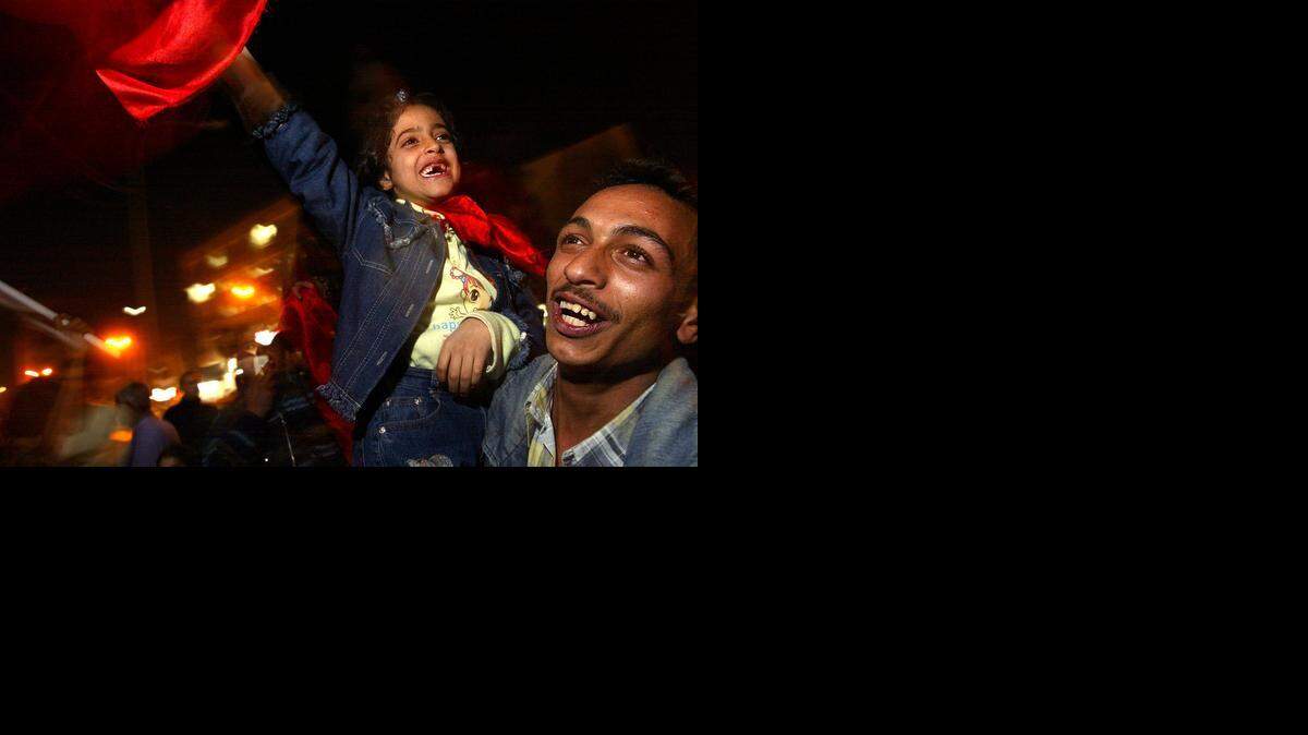 
Hiba Ahmed Qusai, 8, celebrates with her family on the streets of Baghdad, in front of the Iraqi Communist Party Headquarters on Dec. 13, 2003, the day Iraqi leader Saddam Hussein was found in a hole south of his hometown of Tikrit.
